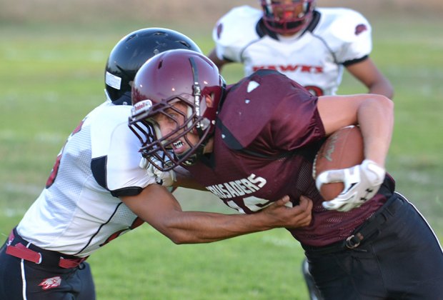 Max Hudson carries the ball around the left end.