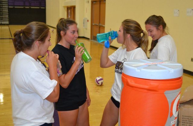 Lemoore's volleyball players take a break after working up a sweat.
